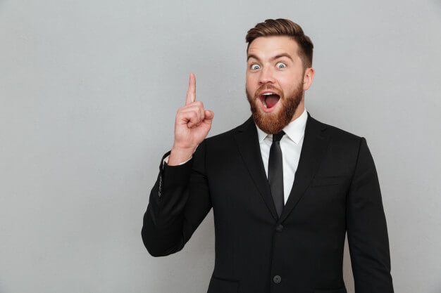 Excited young bearded businessman having an idea